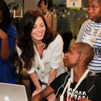 Woman training a young man on a computer
